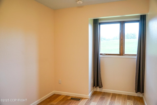 2100 Minerva Way # A6, Anchorage, AK 99515 - unfurnished room with light wood-style flooring, baseboards, and a smoke detector