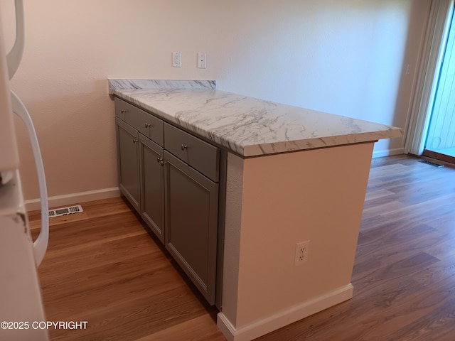 2100 Minerva Way # A6, Anchorage, AK 99515 - kitchen featuring freestanding refrigerator, gray cabinetry, light wood-style floors, baseboards, and a peninsula