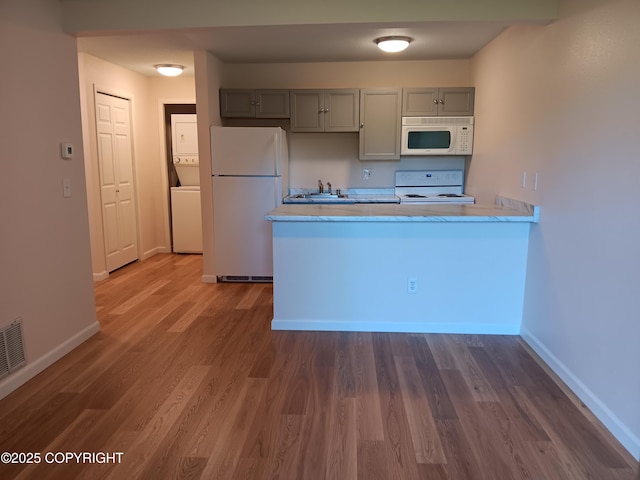 2100 Minerva Way # A6, Anchorage, AK 99515 - kitchen featuring white appliances, gray cabinets, light countertops, and wood finished floors
