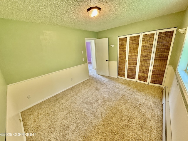 4941 E Rhubarb Cir, Wasilla, AK 99654 - unfurnished bedroom with a textured ceiling and carpet flooring