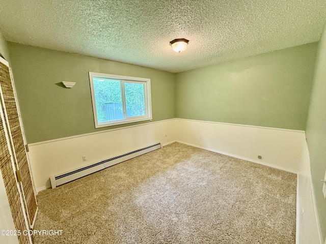 4941 E Rhubarb Cir, Wasilla, AK 99654 - carpeted spare room featuring a baseboard radiator and a textured ceiling