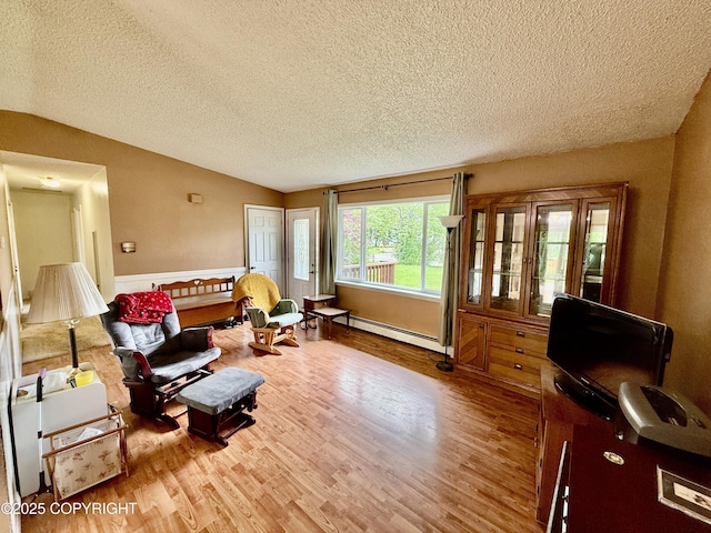 4941 E Rhubarb Cir, Wasilla, AK 99654 - sitting room featuring a baseboard radiator, a textured ceiling, wood finished floors, lofted ceiling, and wainscoting