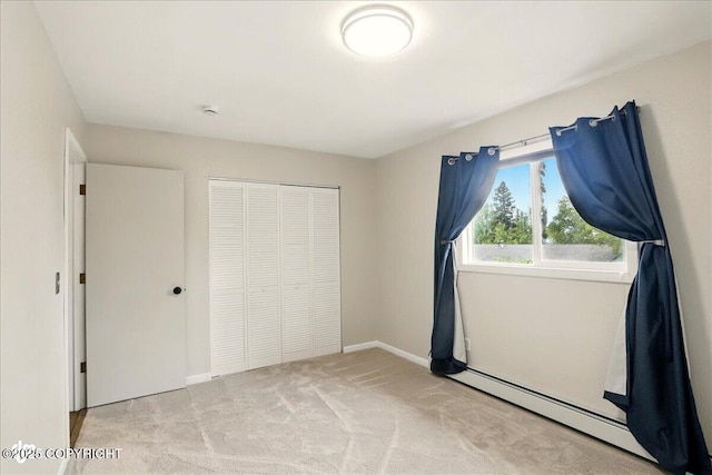 6911 Cheryl St, Anchorage, AK 99518 - unfurnished bedroom with a closet, carpet, a baseboard heating unit, and baseboards
