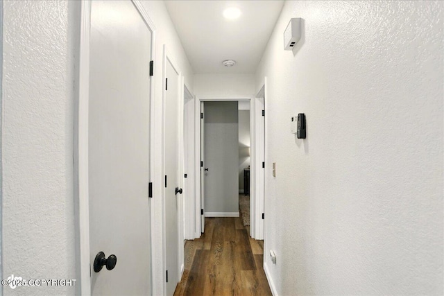 6911 Cheryl St, Anchorage, AK 99518 - corridor with wood finished floors, baseboards, and a textured wall