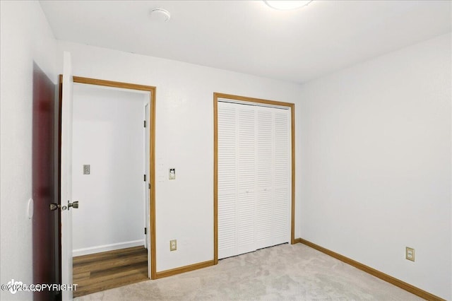 6911 Cheryl St, Anchorage, AK 99518 - unfurnished bedroom with a closet, baseboards, and light carpet