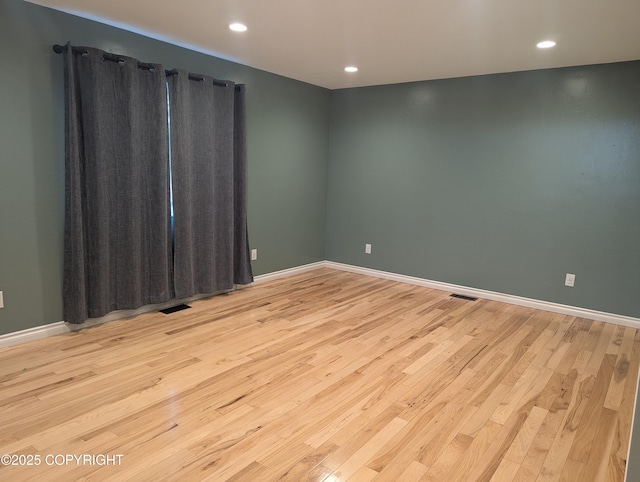 7324 Zurich St, Anchorage, AK 99507 - unfurnished room featuring wood finished floors, baseboards, and recessed lighting
