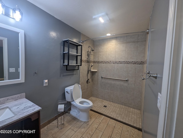 7324 Zurich St, Anchorage, AK 99507 - full bathroom featuring toilet, wood finished floors, vanity, and a tile shower