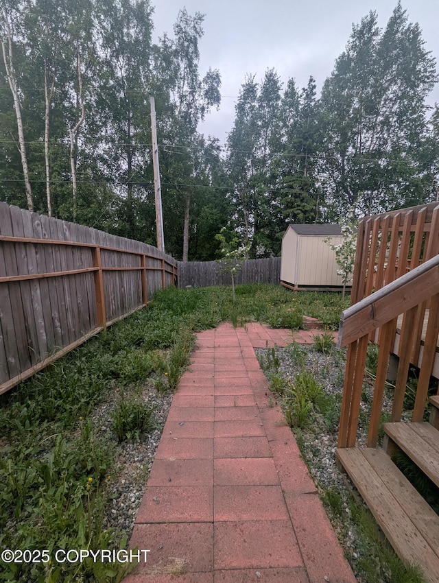 7324 Zurich St, Anchorage, AK 99507 - fenced backyard featuring view of wooded area