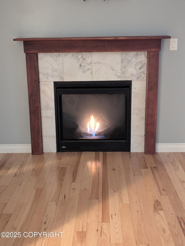 7324 Zurich St, Anchorage, AK 99507 - detailed view of wood finished floors, baseboards, and a fireplace