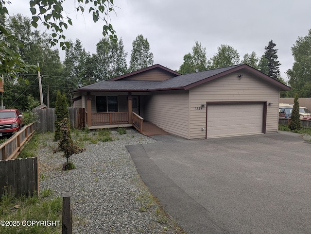 7324 Zurich St, Anchorage, AK 99507 - view of front of house featuring driveway, a garage, a porch, and roof with shingles