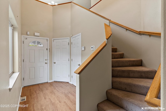 2353 Maritime Loop, Anchorage, AK 99515 - foyer featuring light wood-style floors, stairway, and a high ceiling