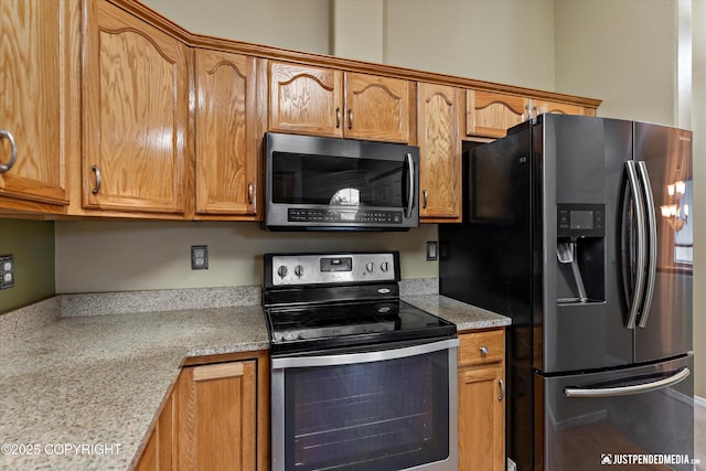2353 Maritime Loop, Anchorage, AK 99515 - kitchen featuring stainless steel appliances, light countertops, and brown cabinetry
