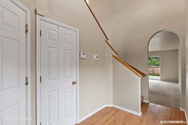 2353 Maritime Loop, Anchorage, AK 99515 - stairs with arched walkways, wood finished floors, and baseboards