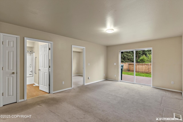 2353 Maritime Loop, Anchorage, AK 99515 - unfurnished bedroom featuring access to outside, carpet floors, baseboards, and connected bathroom