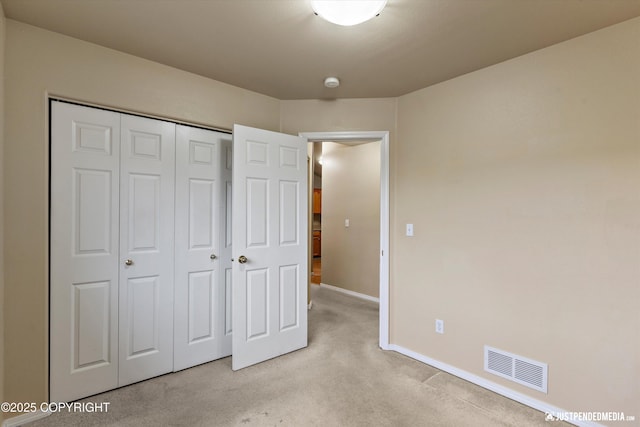 2353 Maritime Loop, Anchorage, AK 99515 - unfurnished bedroom featuring light carpet, a closet, and baseboards
