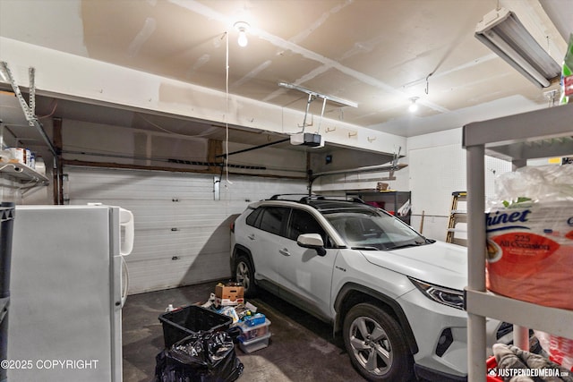 2353 Maritime Loop, Anchorage, AK 99515 - garage featuring freestanding refrigerator and a garage door opener