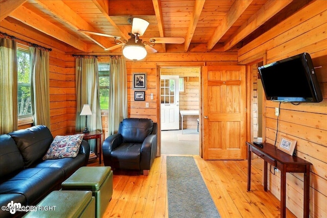 13364 Sterling Hwy, Ninilchik, AK 99639 - living room featuring wood ceiling with exposed beams, light wood-type flooring, wooden walls, and a ceiling fan