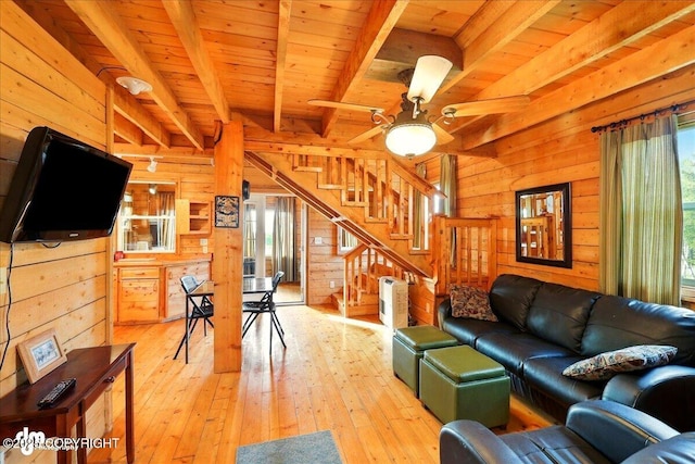 13364 Sterling Hwy, Ninilchik, AK 99639 - living area with plenty of natural light, wood walls, light wood-style floors, wooden ceiling with exposed beams, and stairs