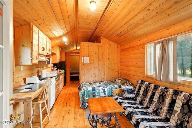 13364 Sterling Hwy, Ninilchik, AK 99639 - bedroom featuring light wood-style flooring, vaulted ceiling, wooden walls, and wooden ceiling