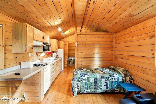13364 Sterling Hwy, Ninilchik, AK 99639 - bedroom with lofted ceiling, wooden ceiling, wooden walls, light wood-style floors, and freestanding refrigerator