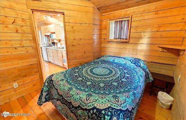 13364 Sterling Hwy, Ninilchik, AK 99639 - bedroom with hardwood / wood-style floors, wood walls, lofted ceiling, and ensuite bathroom