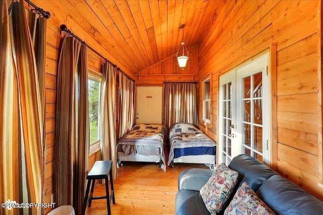 13364 Sterling Hwy, Ninilchik, AK 99639 - bedroom featuring french doors, wooden walls, lofted ceiling, hardwood / wood-style floors, and wood ceiling