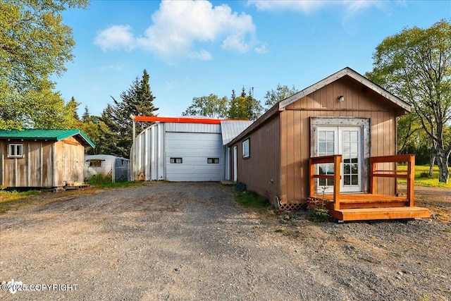 13364 Sterling Hwy, Ninilchik, AK 99639 - view of front of home with an outdoor structure, dirt driveway, and a detached garage