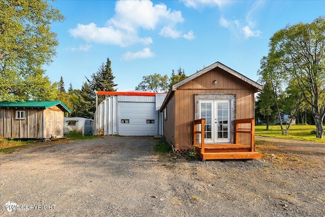 13364 Sterling Hwy, Ninilchik, AK 99639 - view of front of property featuring french doors, an outbuilding, a garage, and driveway