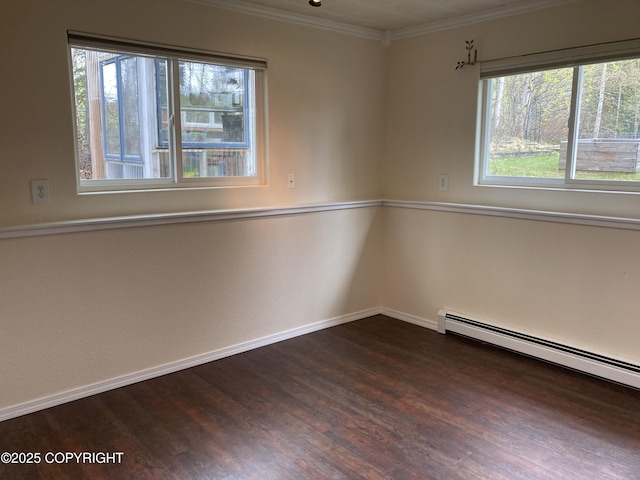 22909 Green Garden Dr, Chugiak, AK 99567 - empty room featuring dark wood-style flooring, baseboards, crown molding, and a baseboard heating unit