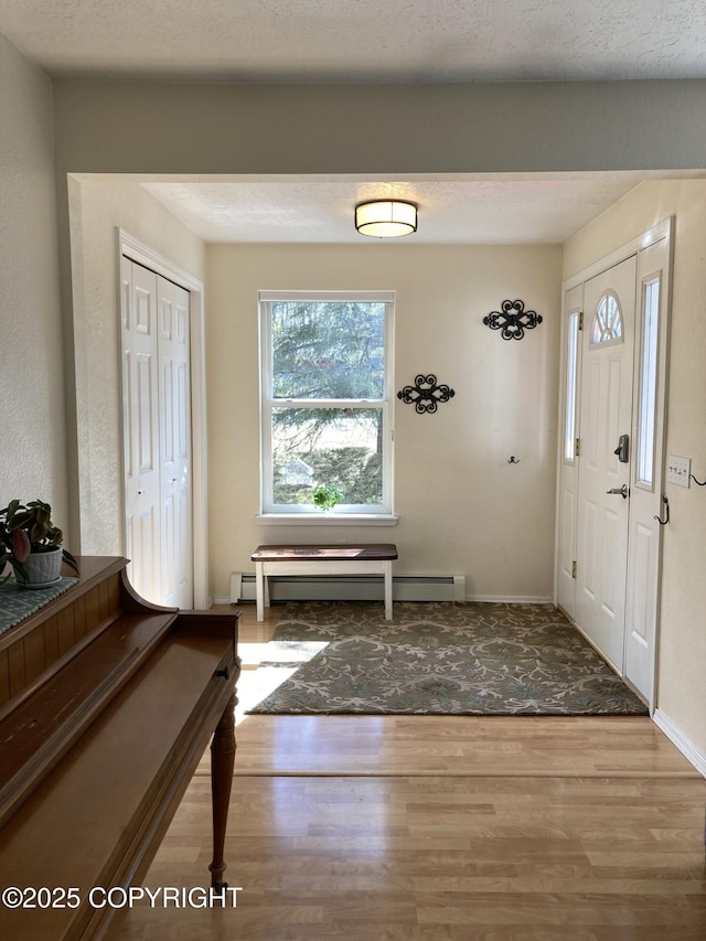 22909 Green Garden Dr, Chugiak, AK 99567 - foyer with a baseboard heating unit, wood finished floors, and baseboards