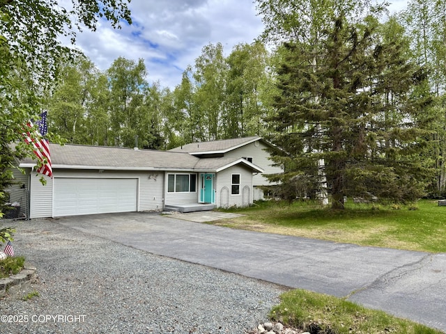 22909 Green Garden Dr, Chugiak, AK 99567 - view of front of house with a garage, asphalt driveway, a front lawn, and roof with shingles