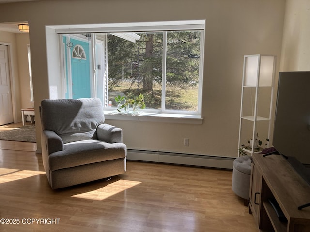 22909 Green Garden Dr, Chugiak, AK 99567 - living area with a baseboard heating unit and light wood-style floors