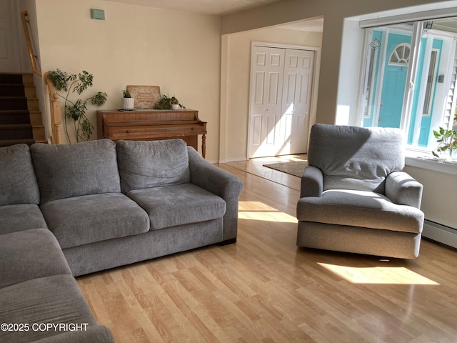 22909 Green Garden Dr, Chugiak, AK 99567 - living area with light wood finished floors, stairs, and a baseboard radiator