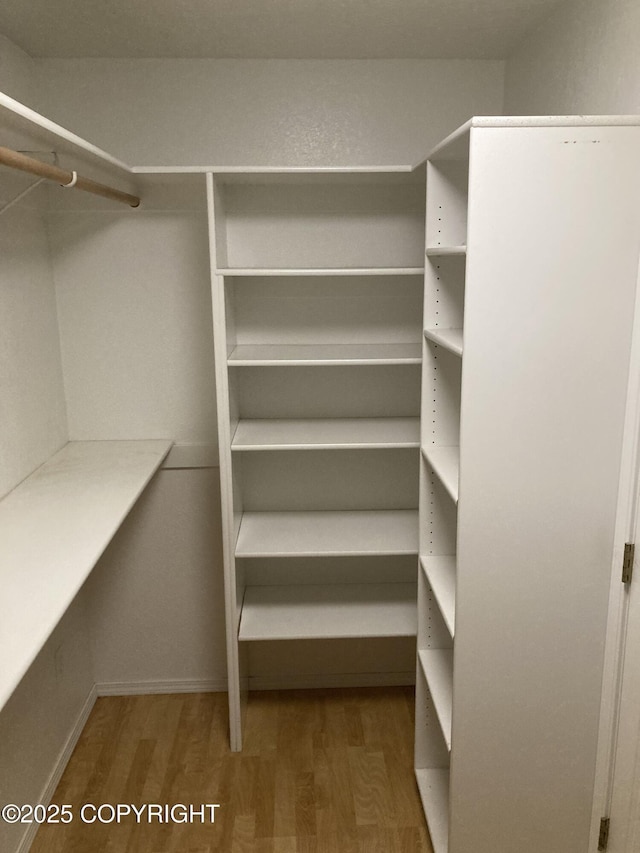 22909 Green Garden Dr, Chugiak, AK 99567 - walk in closet featuring wood finished floors