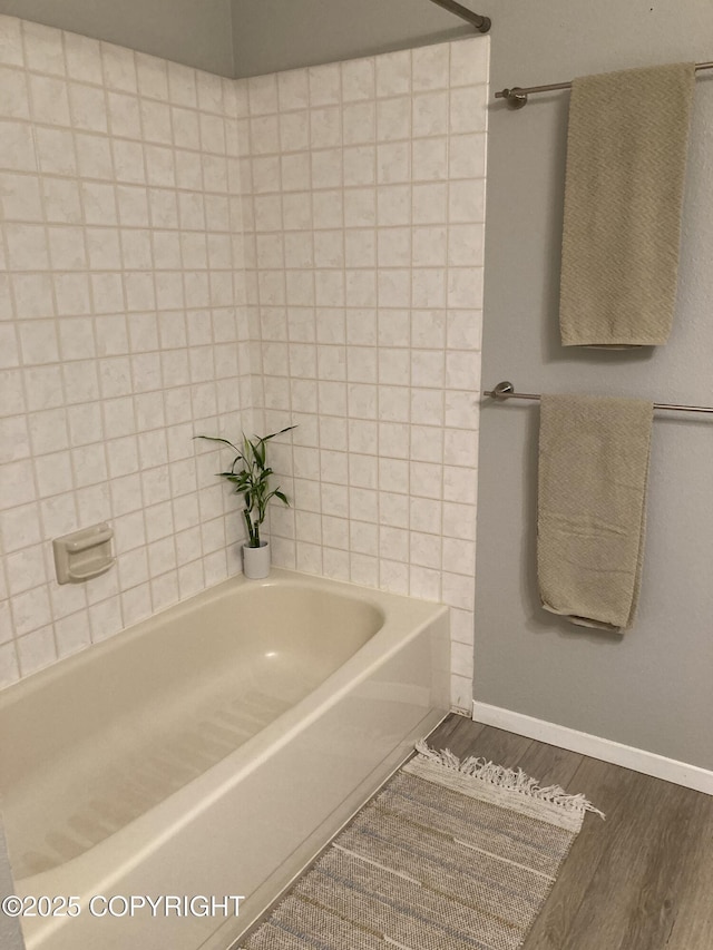 22909 Green Garden Dr, Chugiak, AK 99567 - full bathroom featuring wood finished floors, baseboards, and washtub / shower combination
