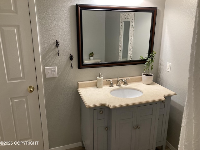22909 Green Garden Dr, Chugiak, AK 99567 - bathroom featuring vanity, baseboards, and a textured wall