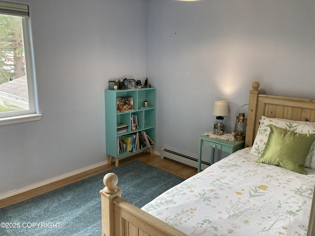 22909 Green Garden Dr, Chugiak, AK 99567 - bedroom featuring a baseboard radiator, wood finished floors, and baseboards