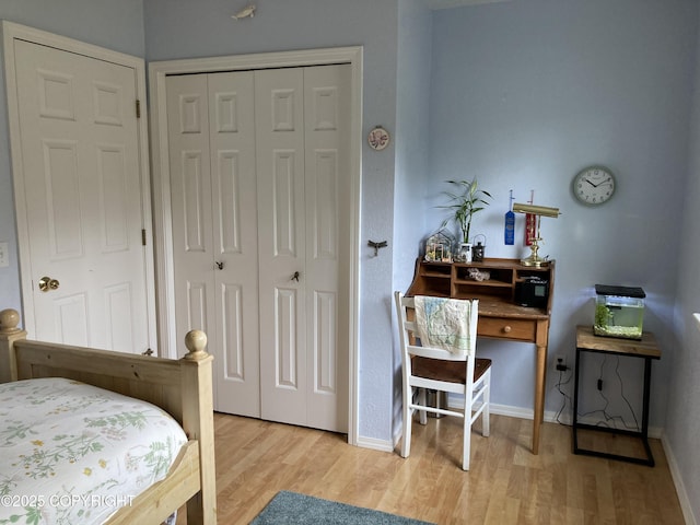 22909 Green Garden Dr, Chugiak, AK 99567 - bedroom featuring light wood-type flooring, a closet, and baseboards