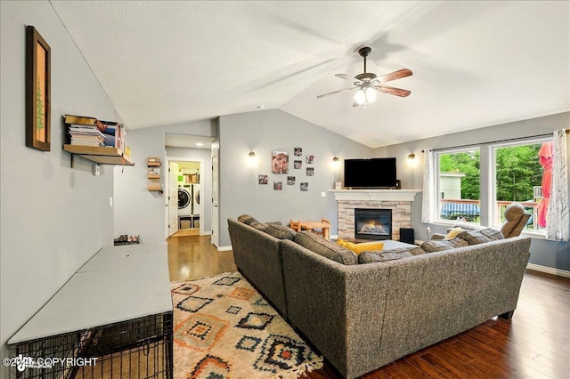2700 S Hatcher Pass St, Wasilla, AK 99623 - living room with washer and dryer, vaulted ceiling, ceiling fan, a stone fireplace, and wood finished floors