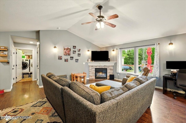 2700 S Hatcher Pass St, Wasilla, AK 99623 - living area with independent washer and dryer, a ceiling fan, a stone fireplace, lofted ceiling, and wood finished floors