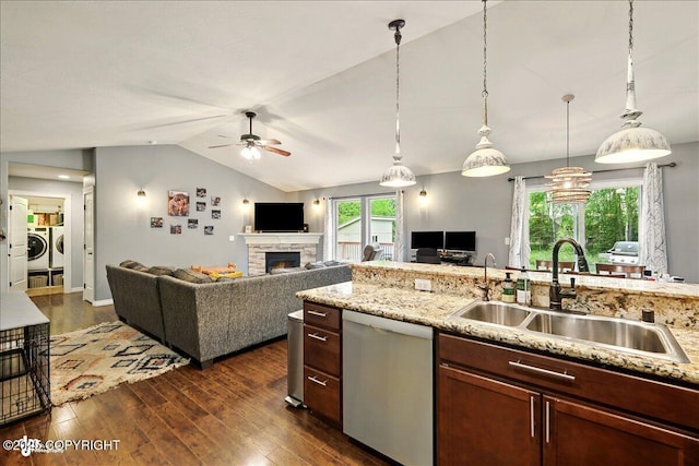 2700 S Hatcher Pass St, Wasilla, AK 99623 - kitchen featuring dishwasher, a sink, washing machine and clothes dryer, a stone fireplace, and ceiling fan