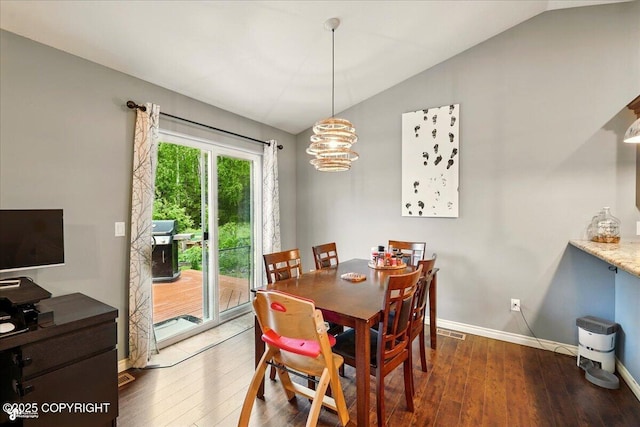 2700 S Hatcher Pass St, Wasilla, AK 99623 - dining space featuring lofted ceiling, baseboards, wood-type flooring, and a chandelier