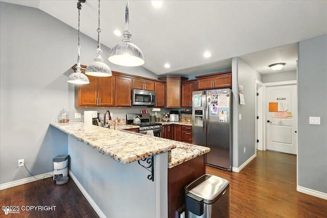 2700 S Hatcher Pass St, Wasilla, AK 99623 - kitchen with stainless steel appliances, vaulted ceiling, a peninsula, dark wood-style flooring, and light stone countertops