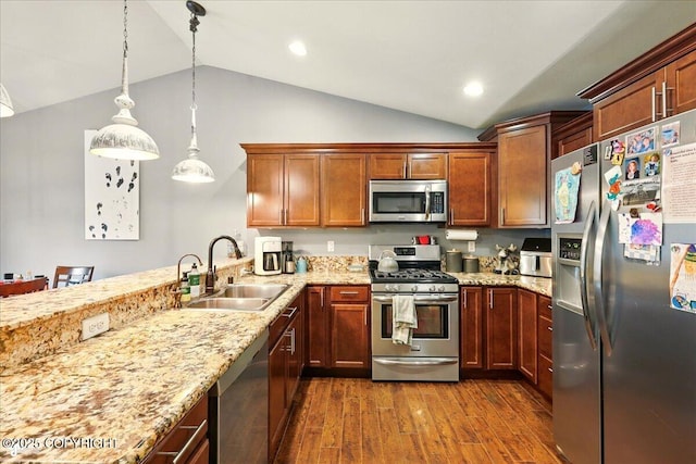 2700 S Hatcher Pass St, Wasilla, AK 99623 - kitchen with appliances with stainless steel finishes, a sink, vaulted ceiling, dark wood-type flooring, and light stone counters