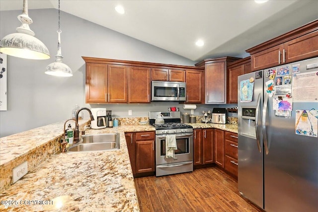 2700 S Hatcher Pass St, Wasilla, AK 99623 - kitchen with stainless steel appliances, a sink, vaulted ceiling, dark wood finished floors, and hanging light fixtures