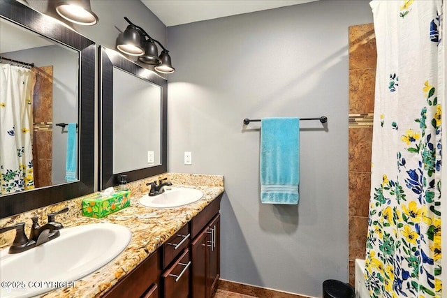 2700 S Hatcher Pass St, Wasilla, AK 99623 - bathroom featuring double vanity, shower / bath combo, and baseboards