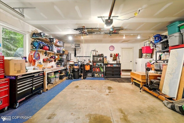 2700 S Hatcher Pass St, Wasilla, AK 99623 - garage with a workshop area and a garage door opener