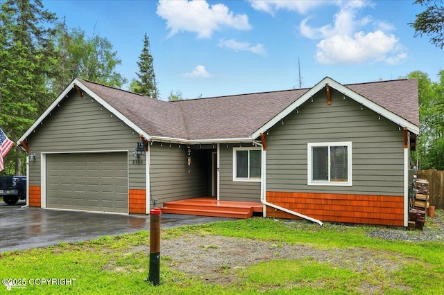 2700 S Hatcher Pass St, Wasilla, AK 99623 - view of front of house featuring roof with shingles, a garage, asphalt driveway, and a front yard