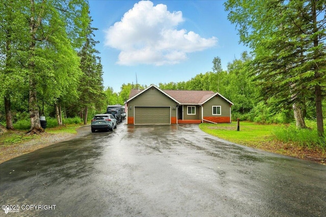 2700 S Hatcher Pass St, Wasilla, AK 99623 - ranch-style home with an attached garage, asphalt driveway, and a front yard