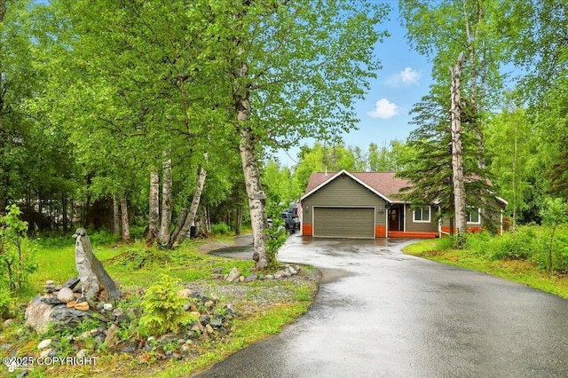 2700 S Hatcher Pass St, Wasilla, AK 99623 - view of front of home featuring asphalt driveway and an attached garage